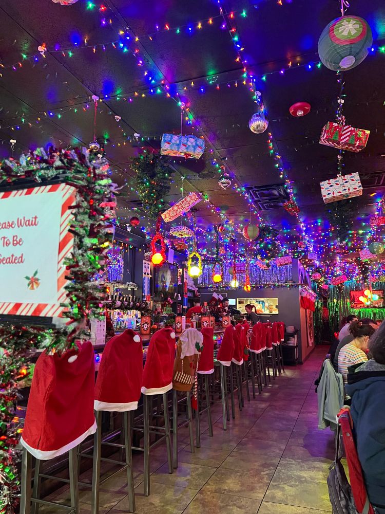 A restaurant with over the top Christmas decorations 