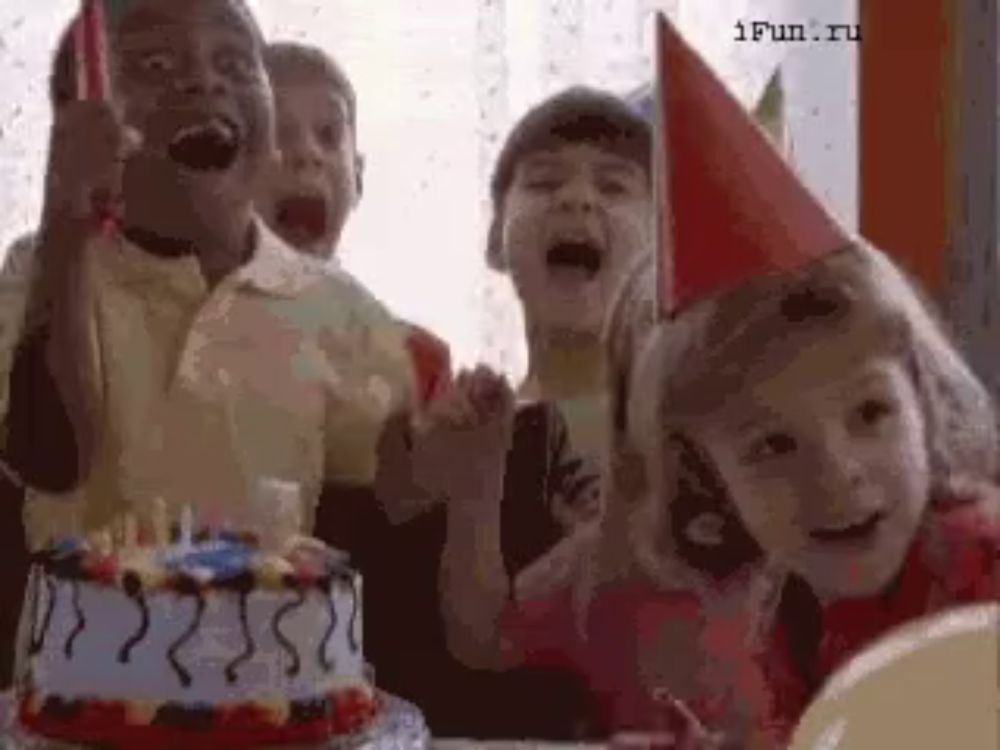 a group of children wearing party hats are celebrating a birthday cake .