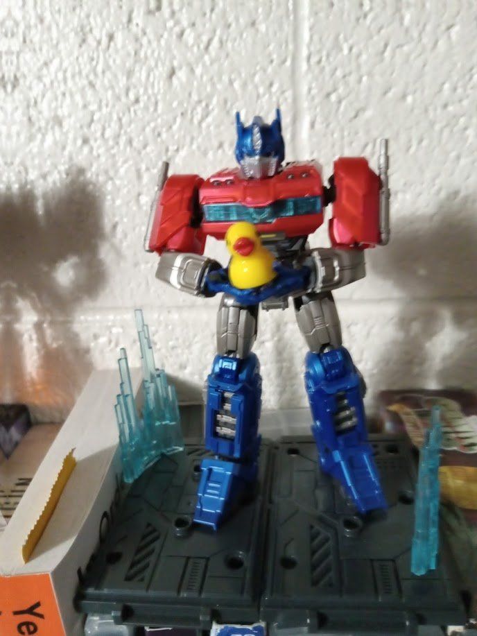 The Blokees Optimus Prime figure posed to hold a tiny plastic duck