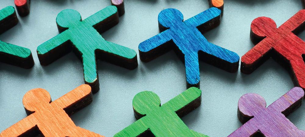 Image of wooden cut out people in many different colours