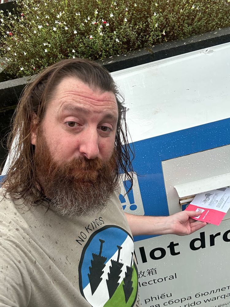 Matthew putting his ballot in a Dropbox. 