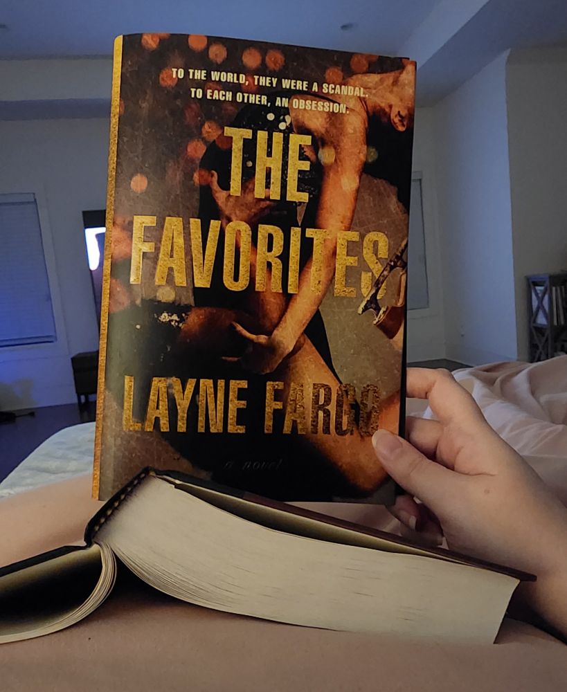 The cover of The Favorites by Layne Fargo. It shows a man holding up a woman while ice dancing. 