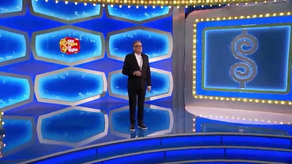 Drew Carey standing at the turntable on the set of The Price is Right, seemingly alone.