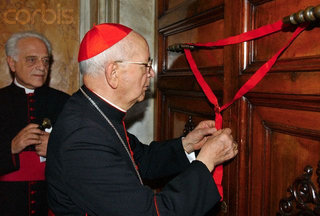 someone sealing the papal apartment with a ribbon and wax seal. It looks very flimsy and I believe I could simply remove the ribbon without breaking the seal. 