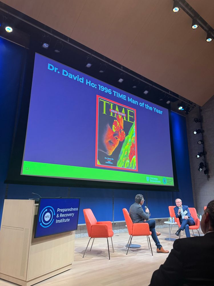 Photo of David Ho being interviewed with his 1996 Time cover on screen