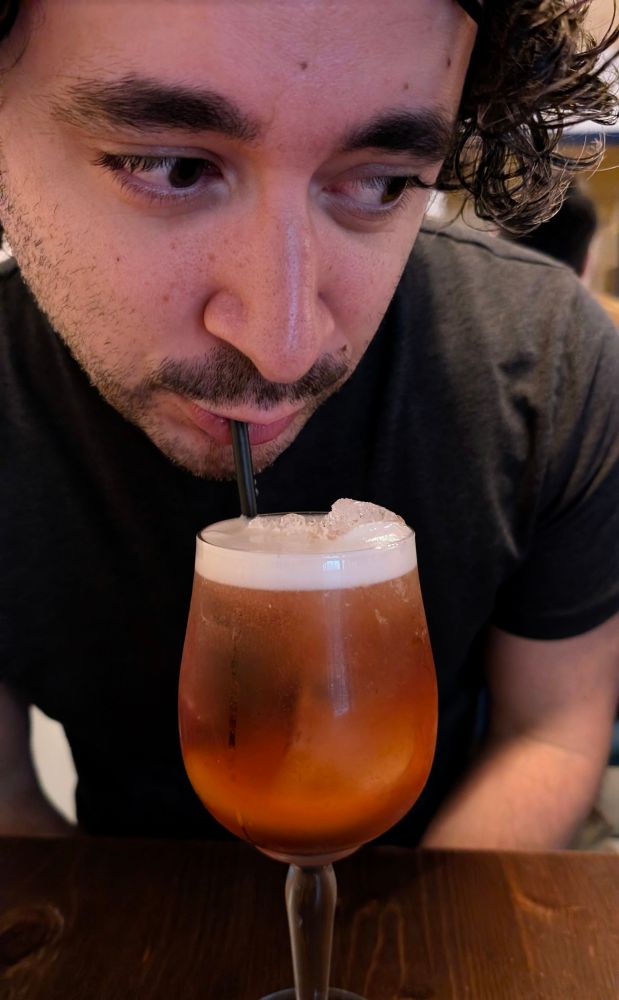 a homosexual drinking a spritz. groundbreaking 