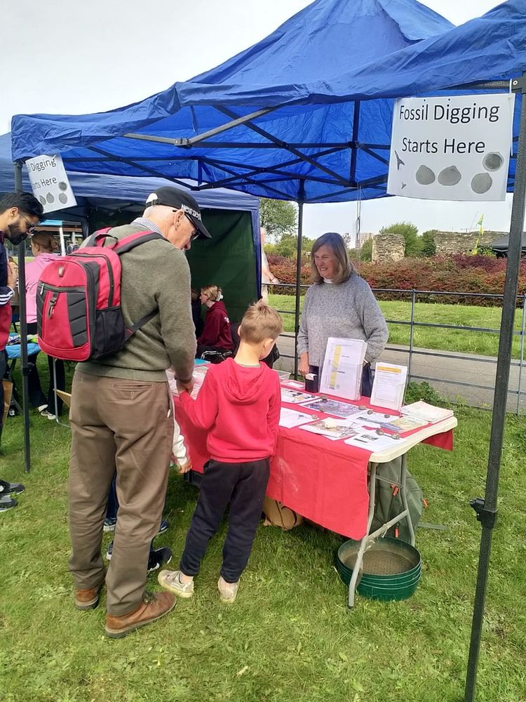 A man and a child are visiting our stall which has a display of fossils and other information about London’s geology. 