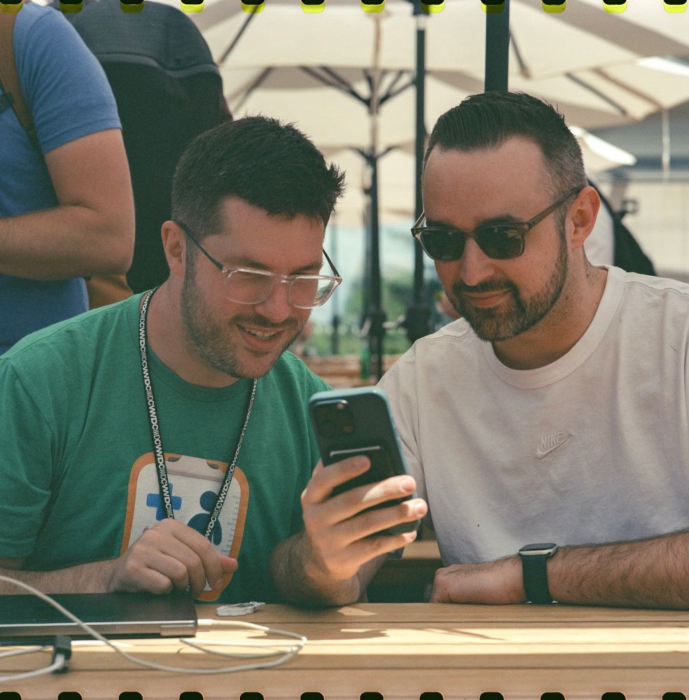 Adrian and Matt looking at a phone 