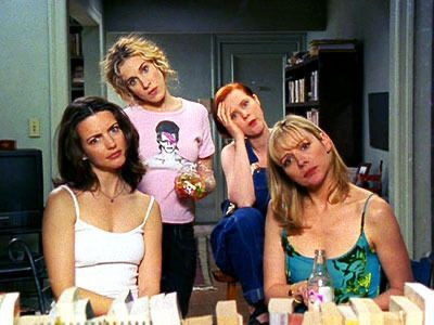 the four white female protagonists of sex and the city watch out Carrie's apartment window with their heads tilted to the left