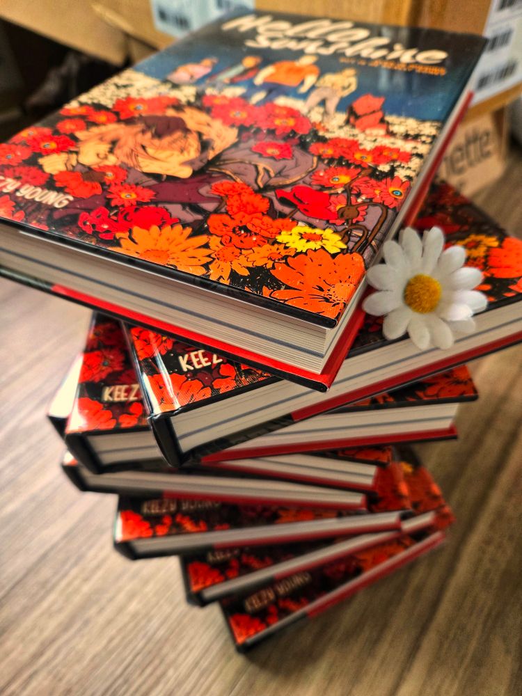 pile of hello sunshine books that I put a daisy on