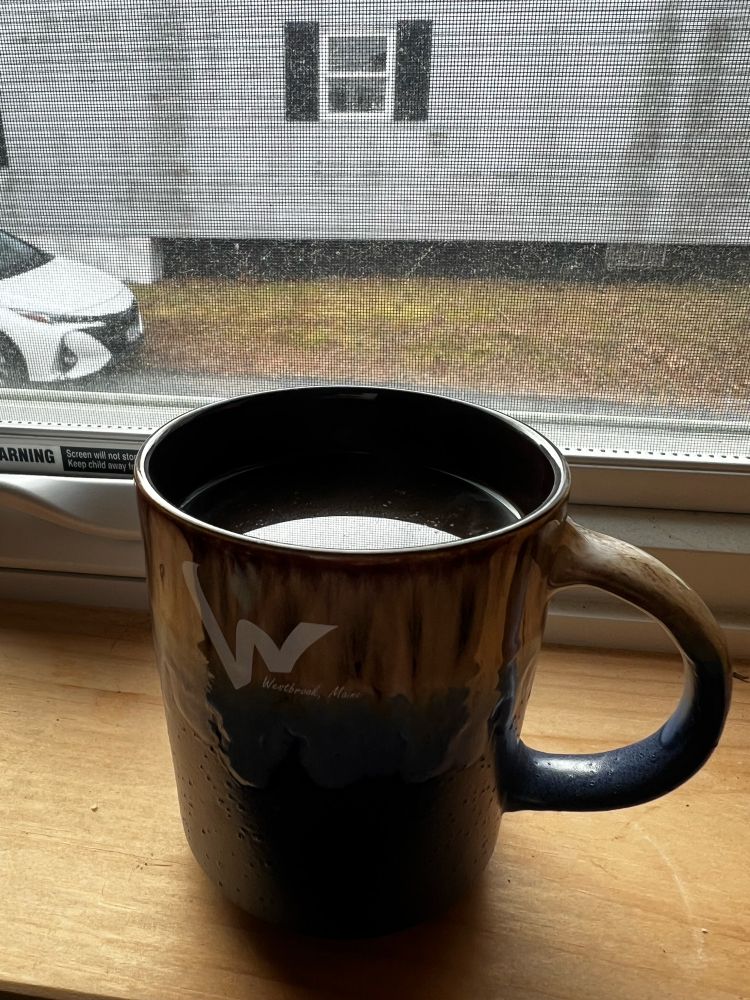 An image of a coffee cup on a windowsill