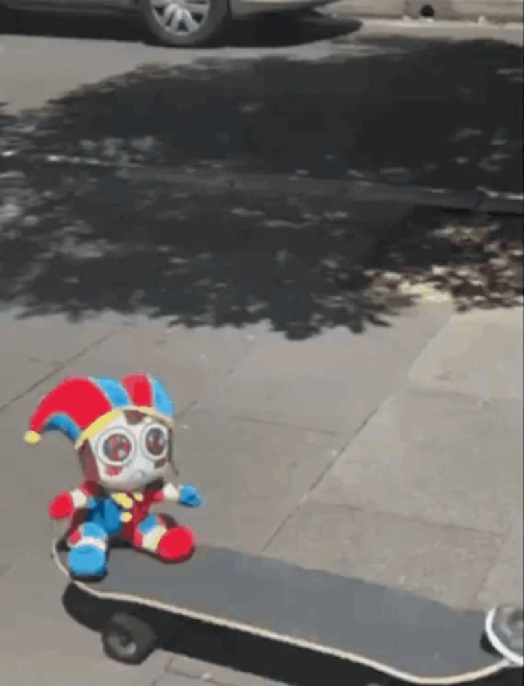 a stuffed animal is sitting on a skateboard on the sidewalk