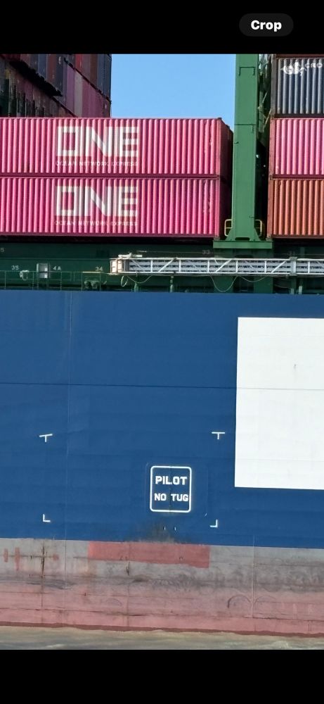 big old ship has a sign reading PILOT NO TUG