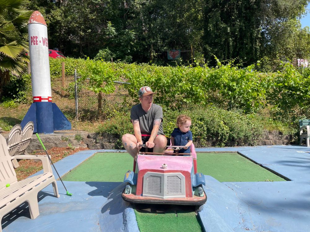 driving a very real tiny pink car with my son 