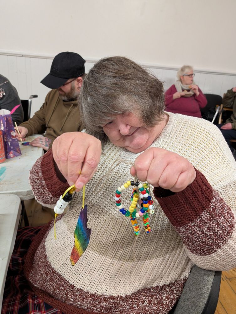 Julie showing us all the decorations she made. They are very colourful.