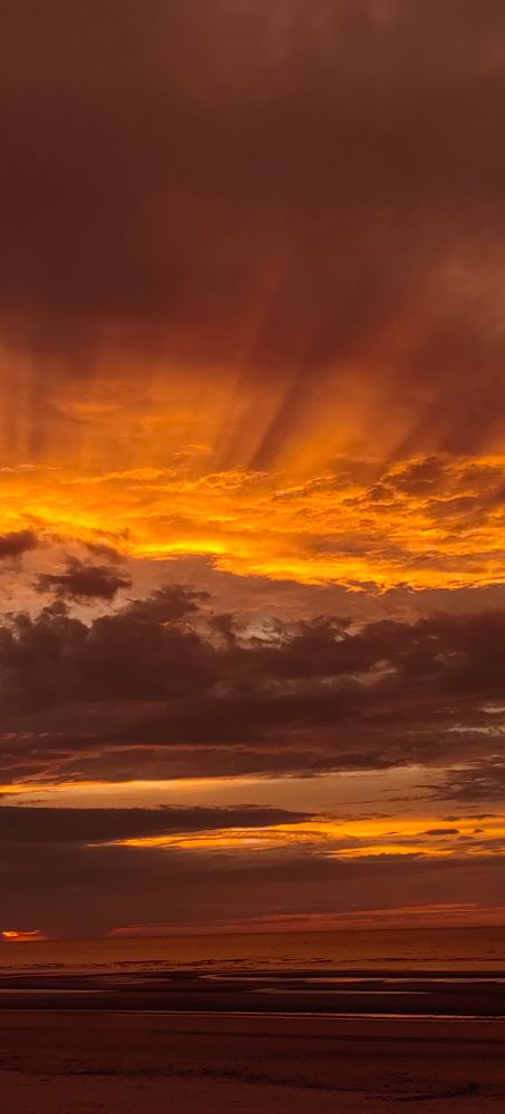 sonnenuntergang, dunkle wolken, nach oben rote strahlen, nach unten rote felder