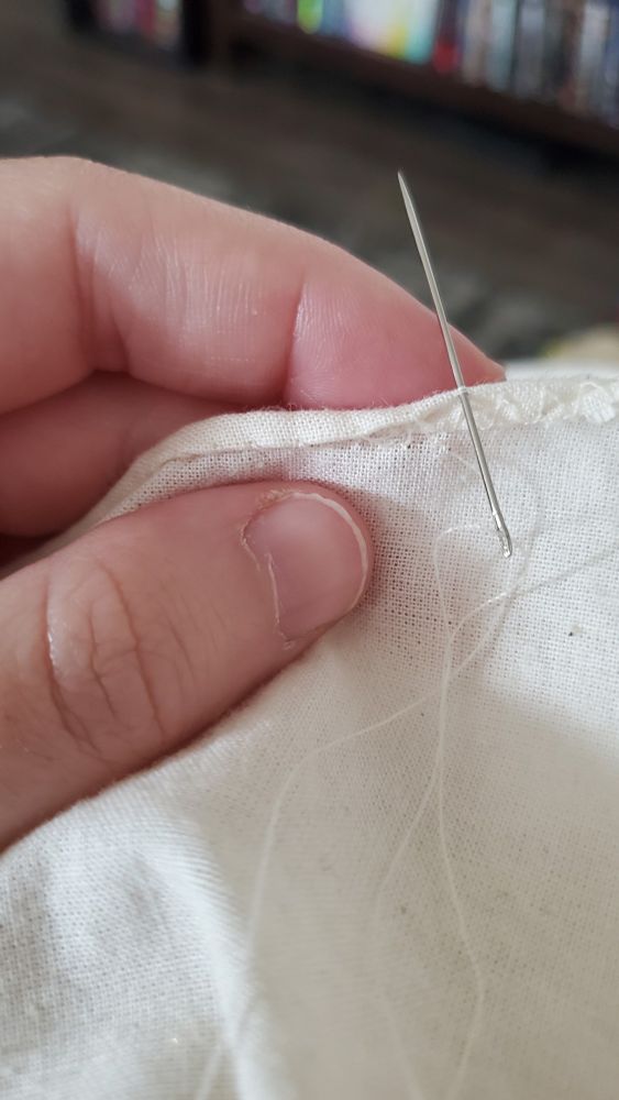 Close up of a hand sewn rolled hem