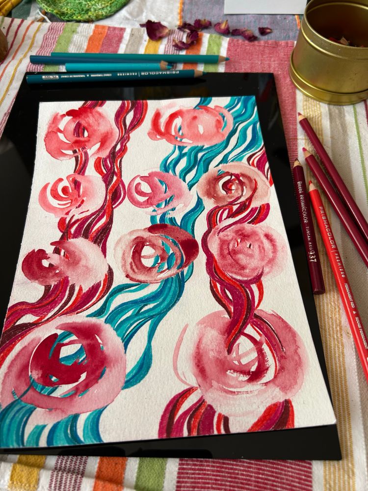 Watercolor swatch-swirls in various red paints, with wavy lines (colored pencils)  in reds and aqua-blue-greens running through them all. Mixed media on a small sheet of 90lb watercolor paper, finished by me today 9-2-25.