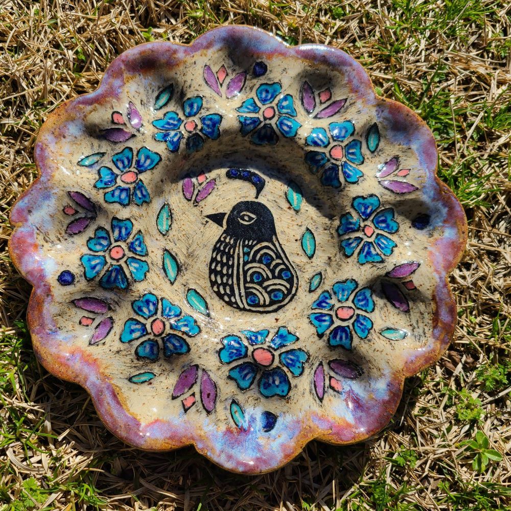Deviled egg plate with a quail in the center surrounded by flowers.