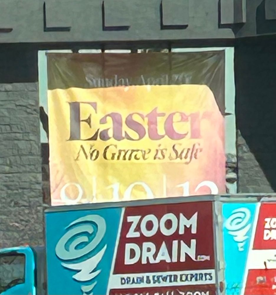 A sign on a church advertising easter services with the slogan “No Grave Is Safe”.