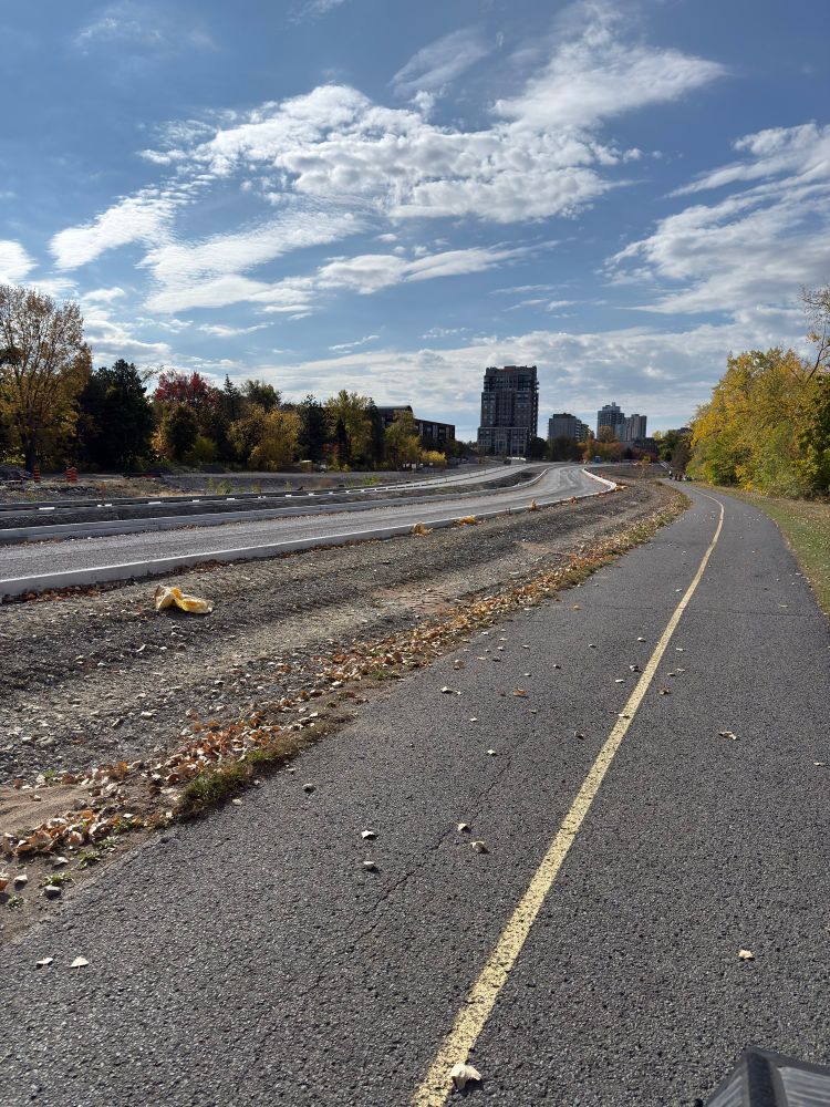 View of the KZM parkway from the multiuse pathway with the fencing gone and the westbound lane sitting unpaved 