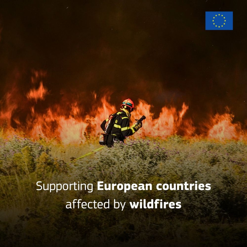 A firefighter in protective gear faces a large wildfire, with flames engulfing dry vegetation. The European Union flag is displayed in the top right corner. Text on the image reads: 'Supporting European countries affected by wildfires.