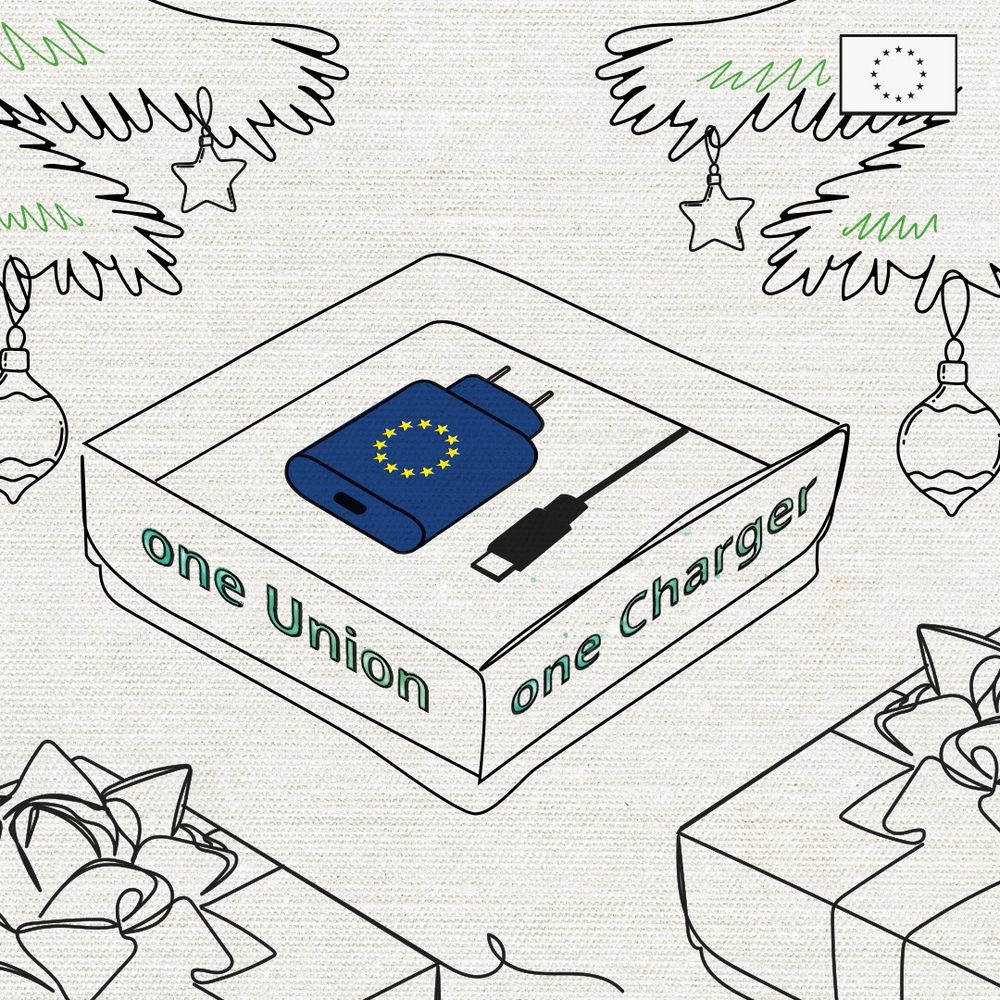 A minimalist illustration showing a packaged charger box labeled "one Union one Charger." The box features an image of a blue charger with the European Union flag symbol and a USB-C cable. The scene is set within a holiday theme, with decorative Christmas trees, ornaments, and gift boxes surrounding the charger box. In the top right corner, there is a small EU flag symbol. 