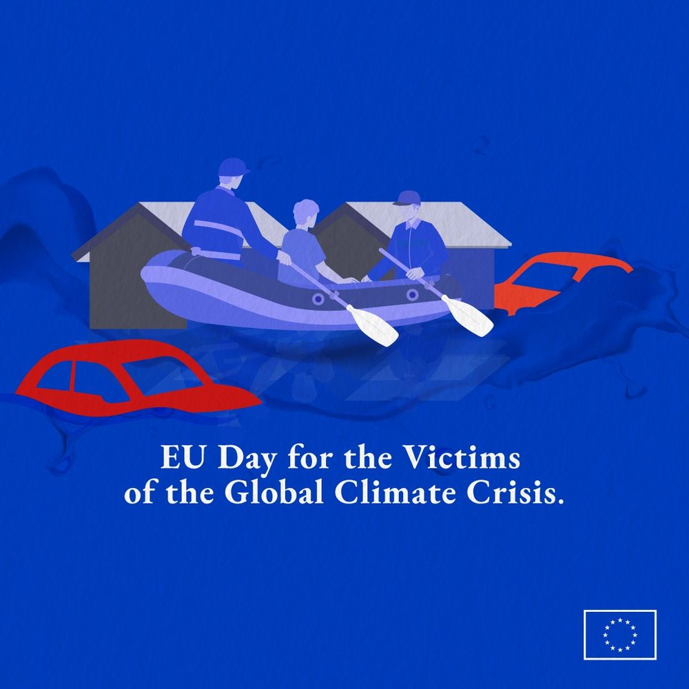 A digitally illustrated scene depicting two members or the rescue team and one individual paddling a small inflatable boat through deep floodwaters in a residential area. The water reaches halfway up the doors and windows of houses, and partially submerged red cars are floating around. The background and general colour scheme are blue. The text reads: 'EU Day for the Victims of the Global Climate Crisis.' A European Union flag is positioned in the bottom right corner.  