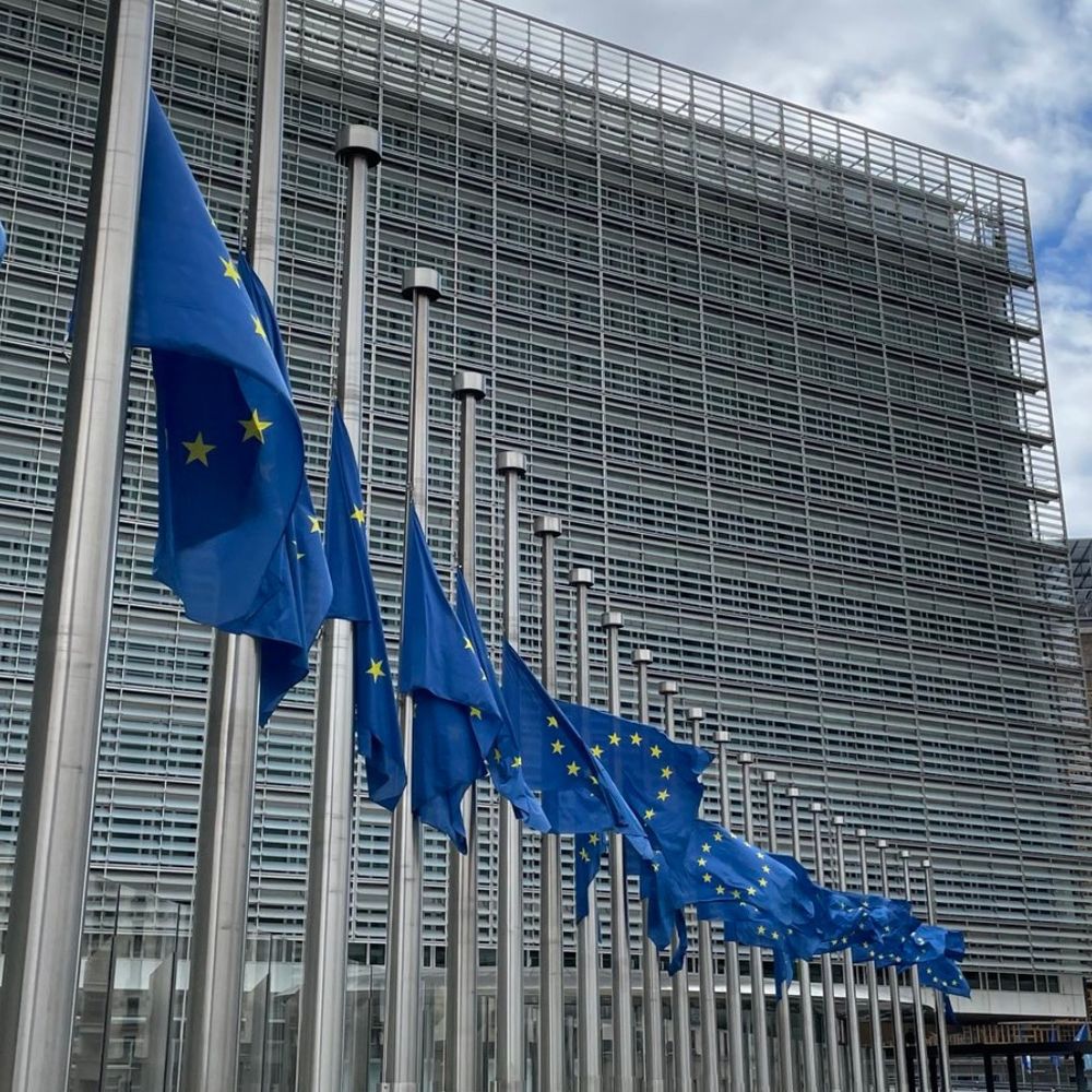 A photo showin half-mast EU flags in front of the Berlaymont Building, the European Commission's headquarters in Brussels, Belgium. 