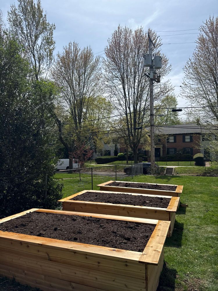 Three raised beds by absolutely filled with dirt. 