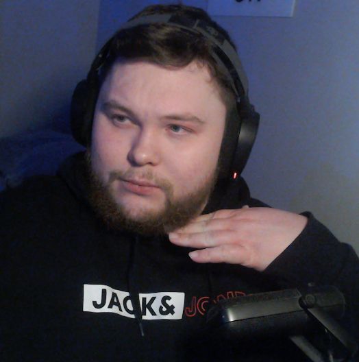 Picture of me in a black hoodie with headphones on