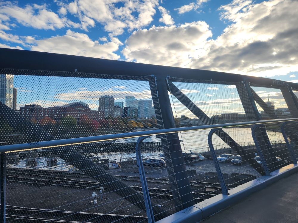 View of the Charles and Boston just inside the locks and on the footbridge above the commuter rail tracks leading out of North station. Some colorful fall foliage along the water.