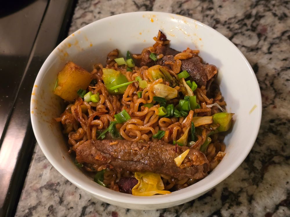 packet noodles boiled and stir fried with the shin ramen powder, beef, veggie oil, garlic, cabbage, broccoli, and scallions 