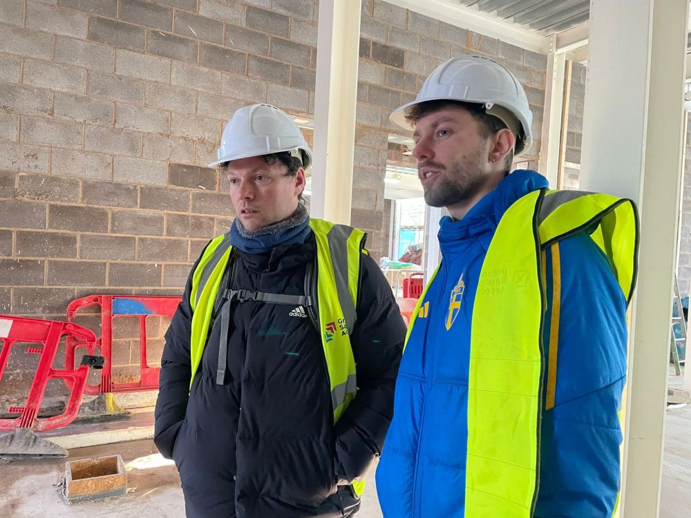 Lee and James standing next to each other at the building site