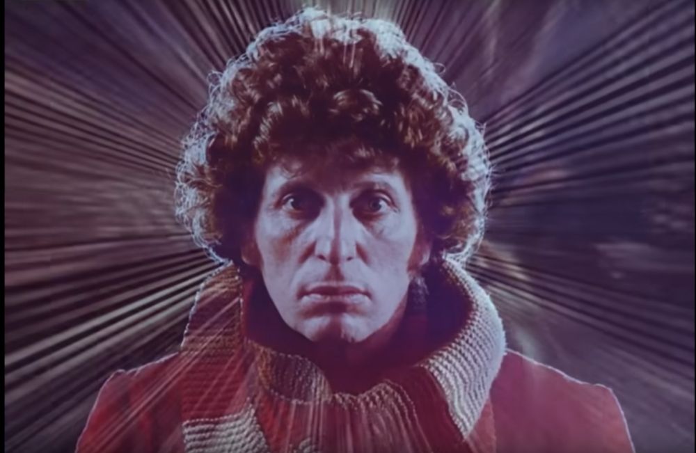 Tom Baker as the 4th Doctor in a red jacket and scarf staring into the camera with a streak-like background and looking really transparent. 