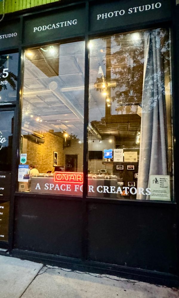 photo of a coworking store front with signage that says “a space for creators”