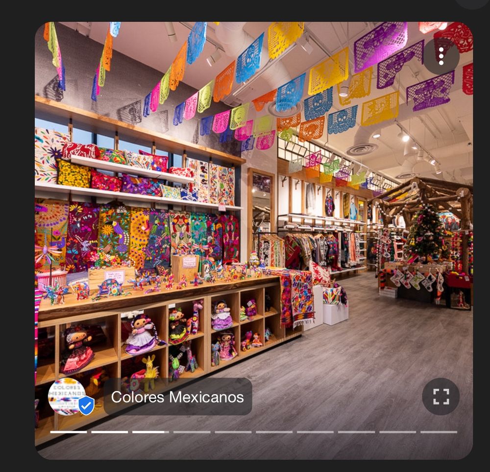 a google photo of the colores mexicanos store filled with colorful crafts and hangings 