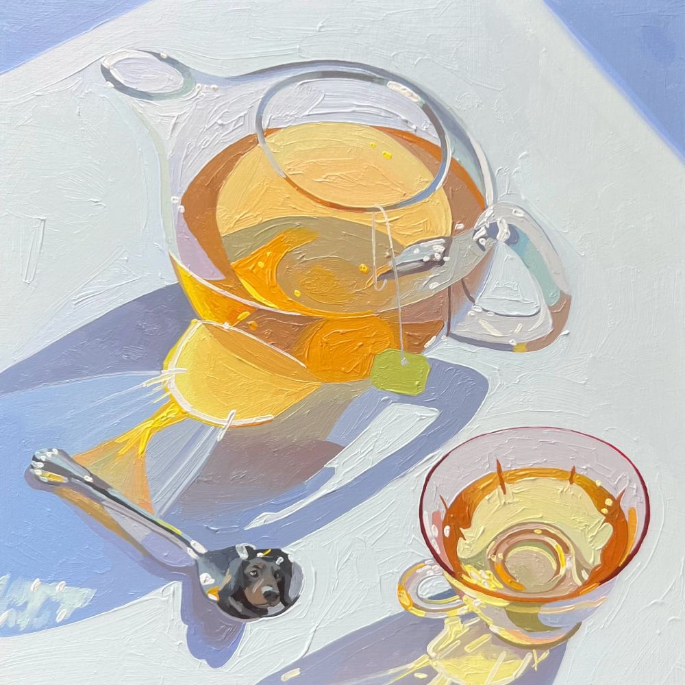 Still life painting of a glass teapot, glass teacup, and silver teaspoon with a small dog’s face reflected in the spoon. 