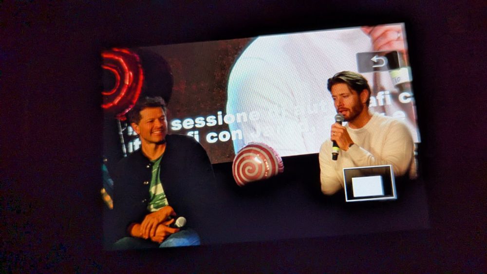 Misha and Jensen on stage. Jensen talking