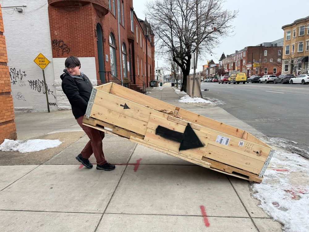 Voxel Technical Director Alec Sparks hauls the packaging from the FedEx truck to the sidewalk.