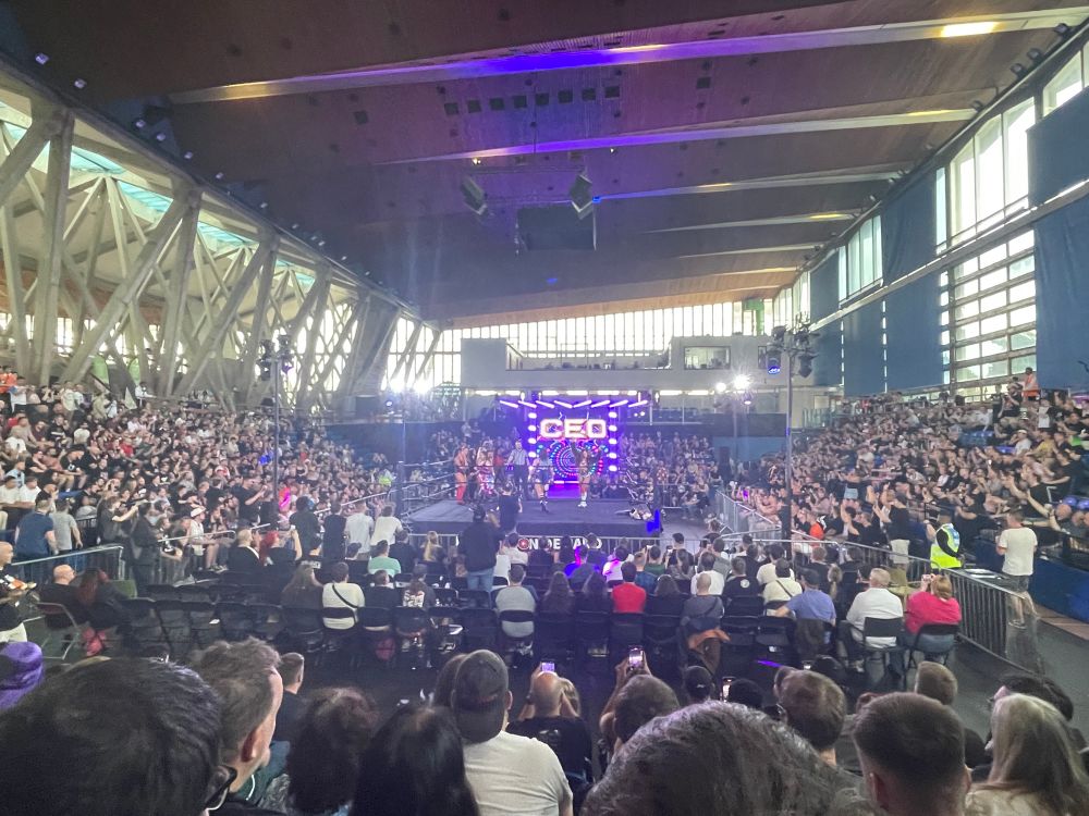 wrestling ring in a big sports arena. a big crowd around it