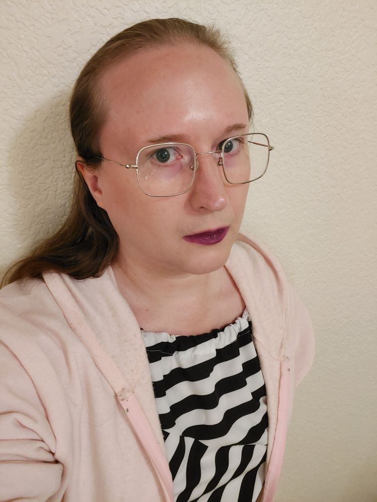 concerned t girl in pink sweatshirt black and white striped dress glasses purple lipstick long brown hair hand on hip scolding u. hot.