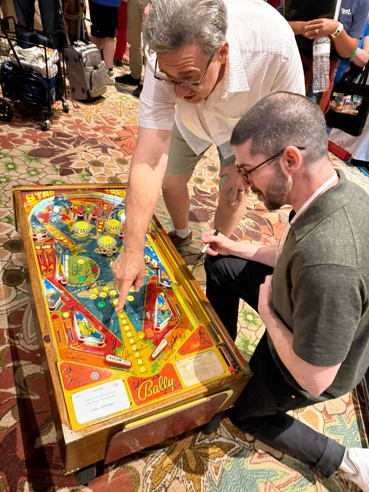 Composer Chris signing a cool old Trek pinball machine. Lots of great sigs on this thing!