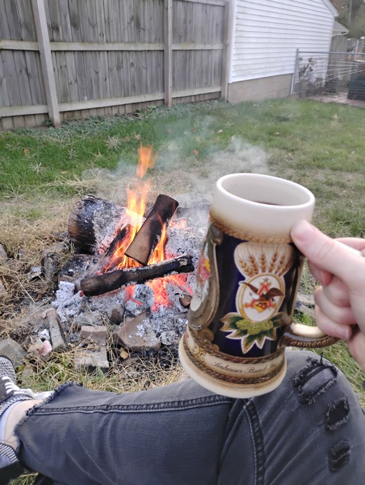 Holding up a Bierstein to the small bonfire I'm sitting in front of
