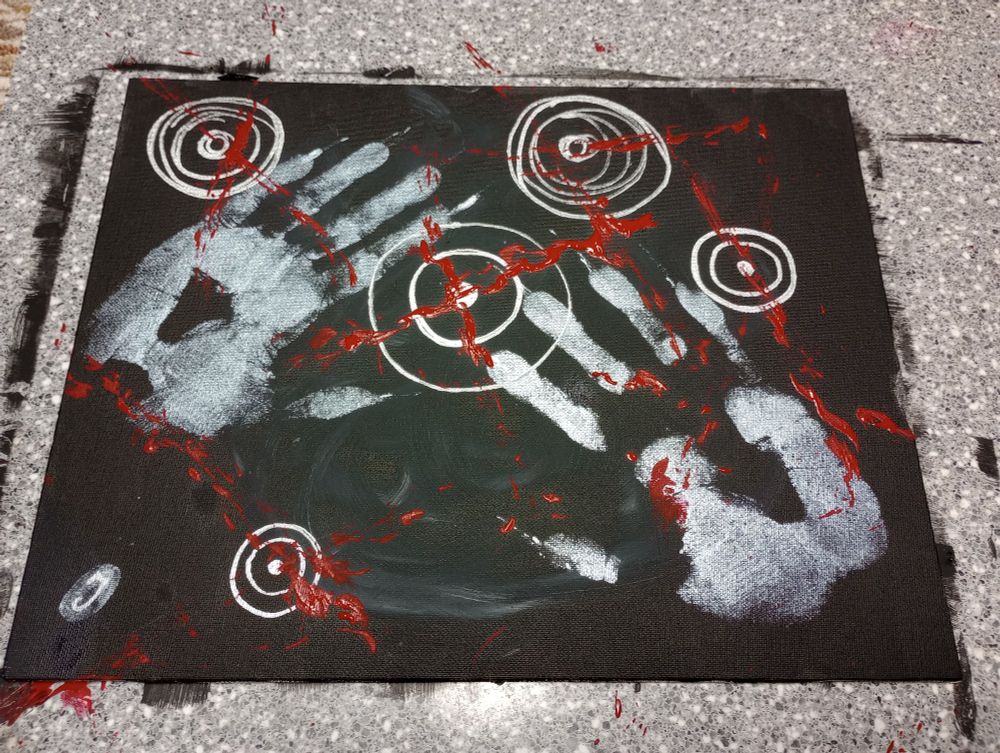 A black canvas painted with silver target rings and heavy hand prints. A red paint covered chain whip was used to strike the canvas as close to the targets as possible 
