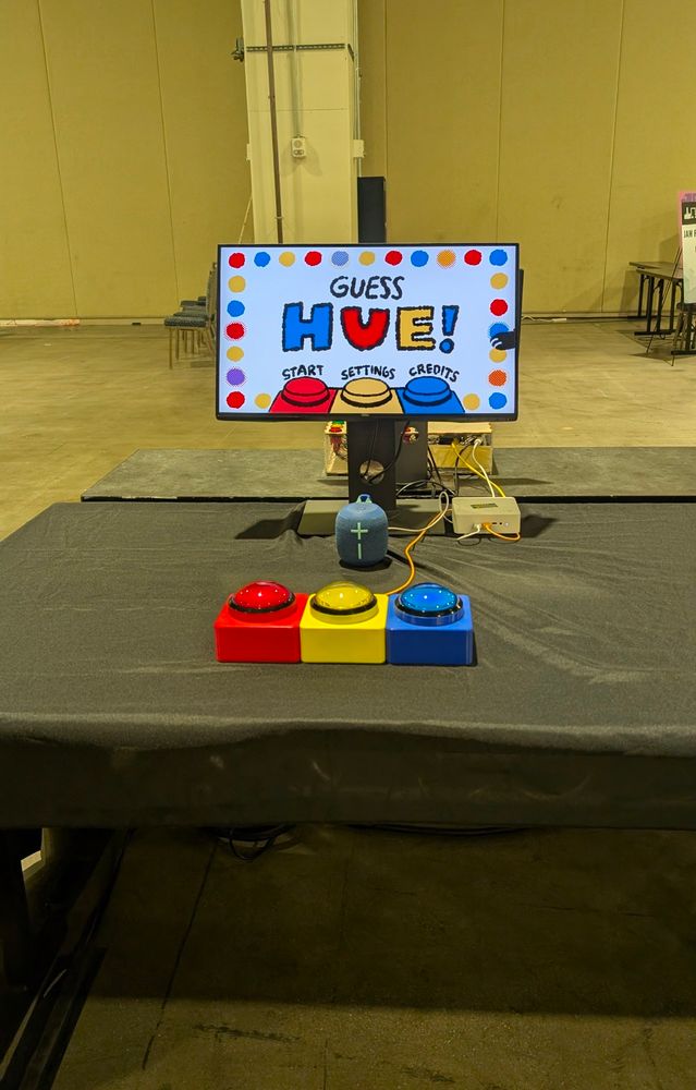 My game, Guess Hue, set up on a table in a brightly lit expo hall