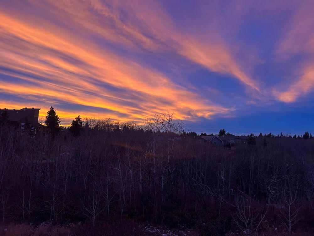 Sunset with azure clouds mixed with the orange highlights 