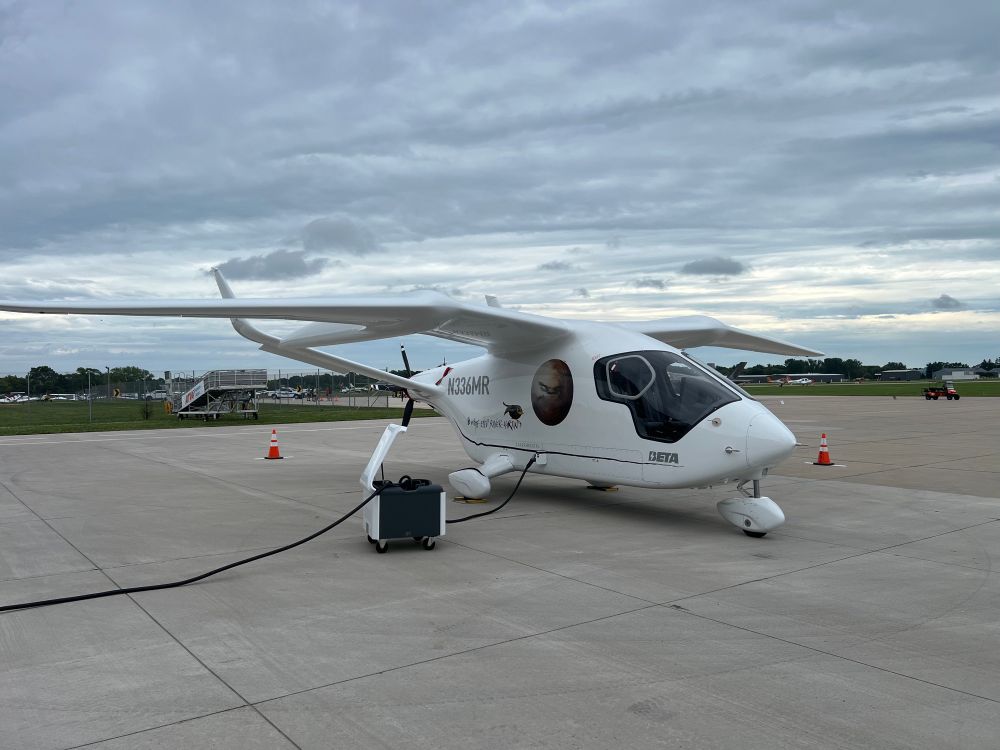 Alia CX300 recharging at Basler FBO in Oshkosh for Airventure 2025. Pusher propeller and split tail. Wings have notable bend in span. Cabin is composite with huge windows.