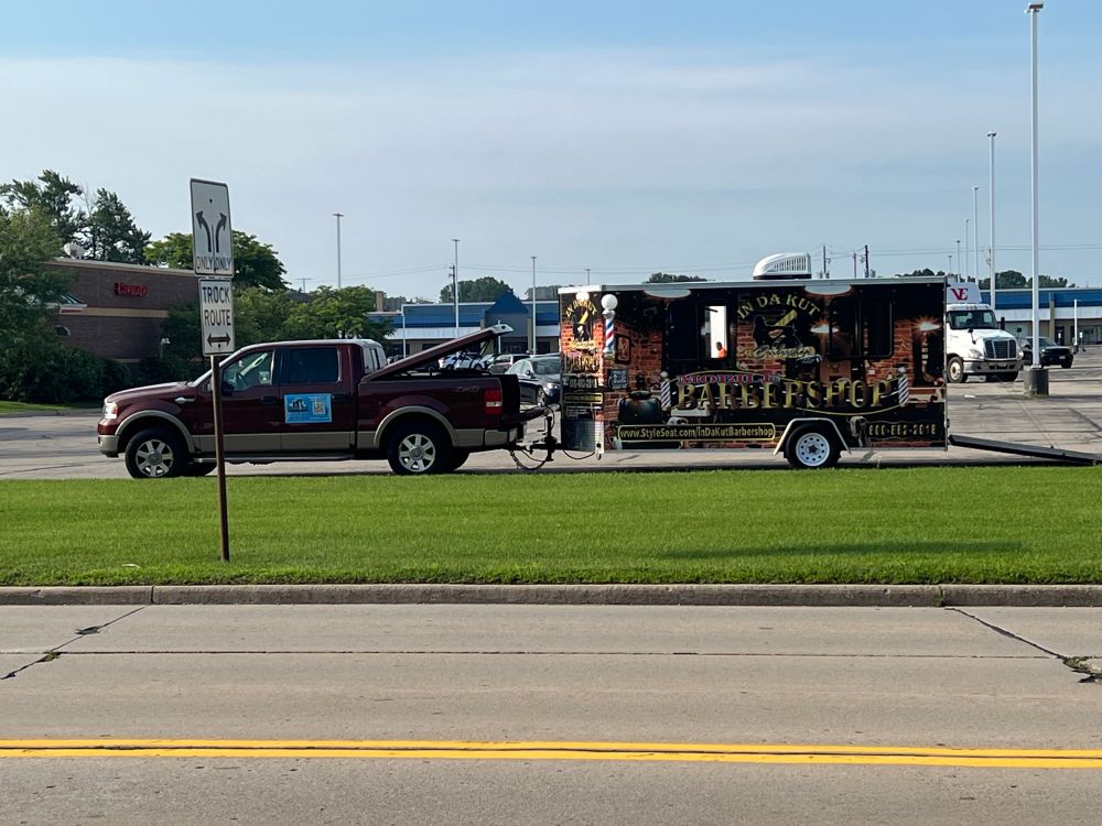 Barbershop in a trailer, parked in an abandoned strip mall.