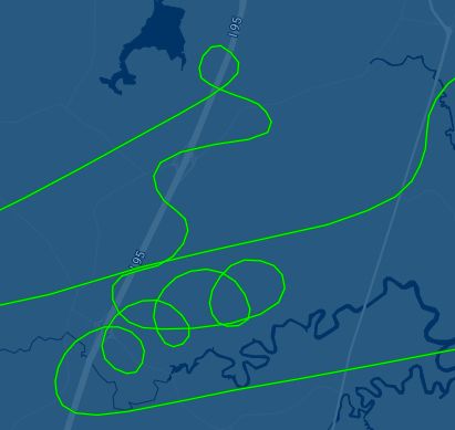 Radar image showing aircraft making lazy circles in the air while drifting to the east due to wind, then doing some practice turns over a highway.